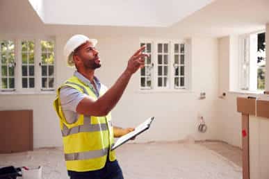 Home inspector evaluating an accessible electrical panel and equipment during a pre-listing house inspection